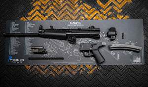 Disassembled MP5 placed on a Cerus Gear gun cleaning mat with detailed labeled schematics, laid over a rugged industrial floor.