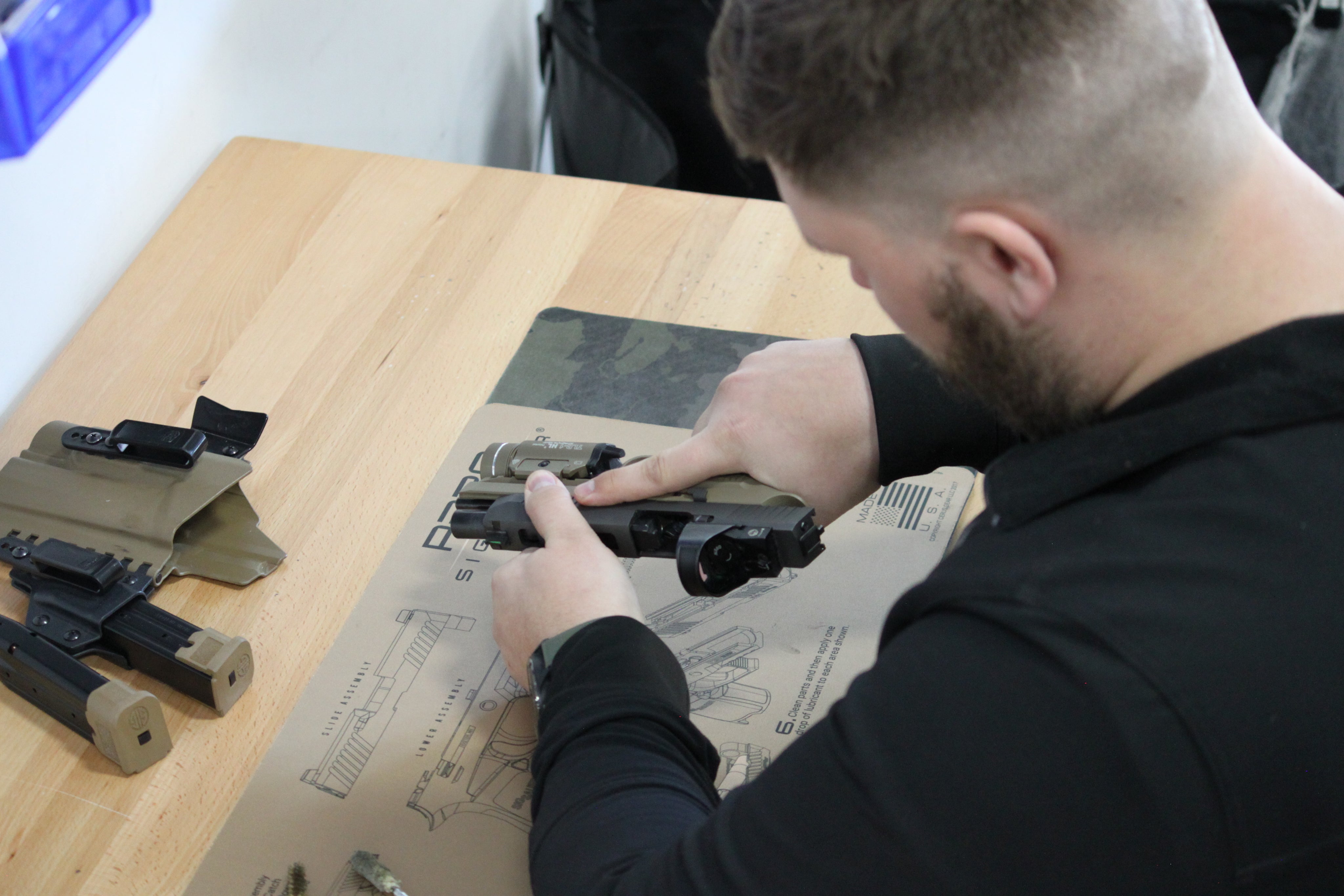 Man fixing his gear using Cerus Gear Mat